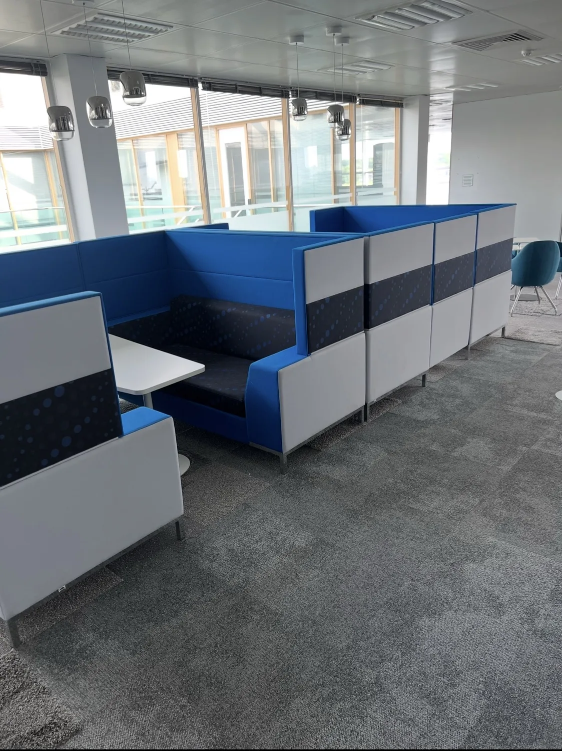 Blue upholstered office seating booths and partitions